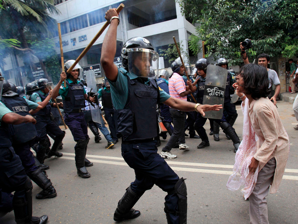 The protester in Bangladesh about to be smashed with a baton